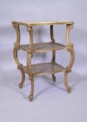A C19th Italian giltwood three tier serpentine shaped etagere, with inset marble top and caned