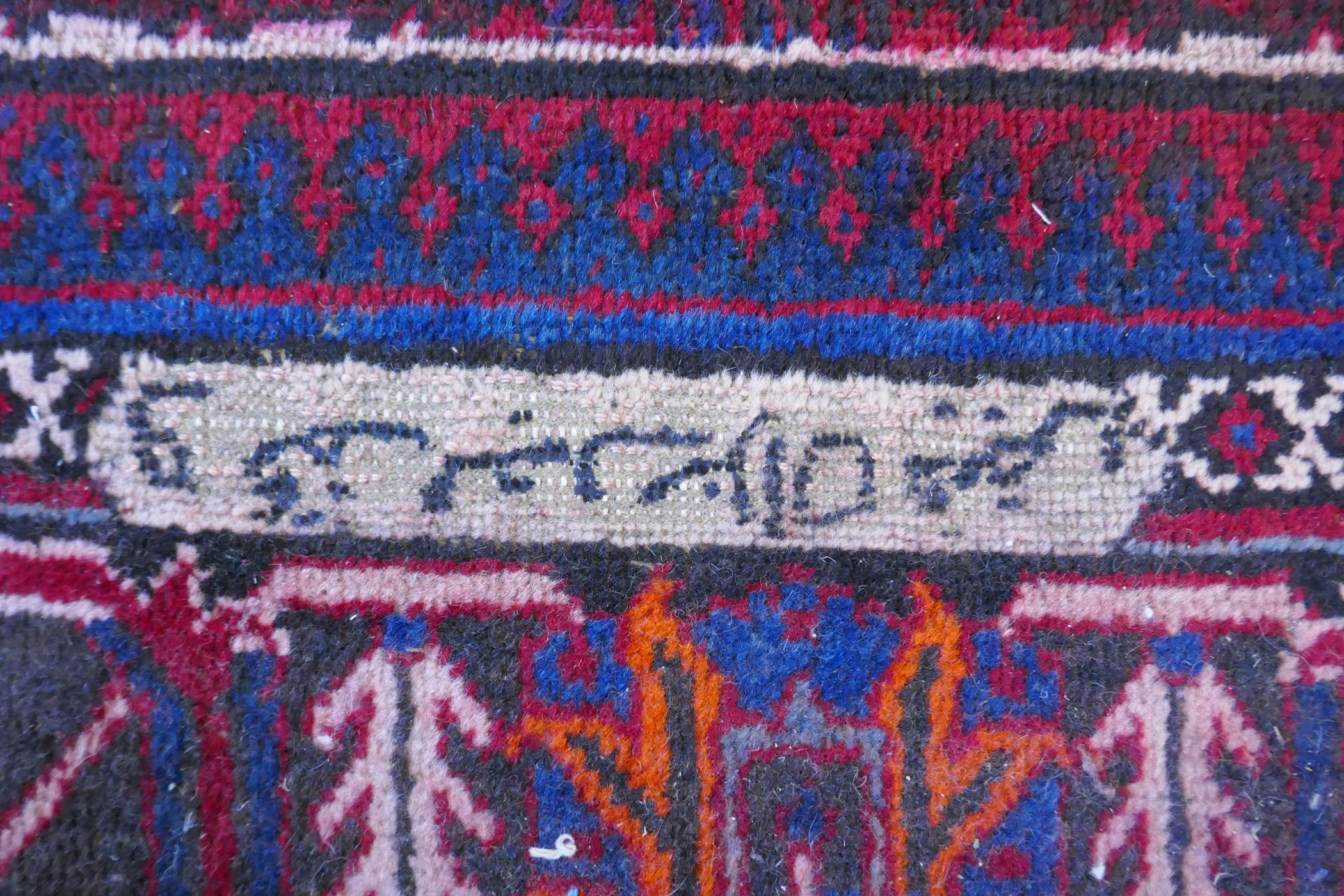 A claret and blue ground Persian Joshaghan tribal carpet with traditional medallion design, - Image 5 of 7