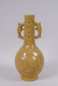A Chinese yellow ground Ge ware bottle vase with two handles, impressed mark to base, 22cm high