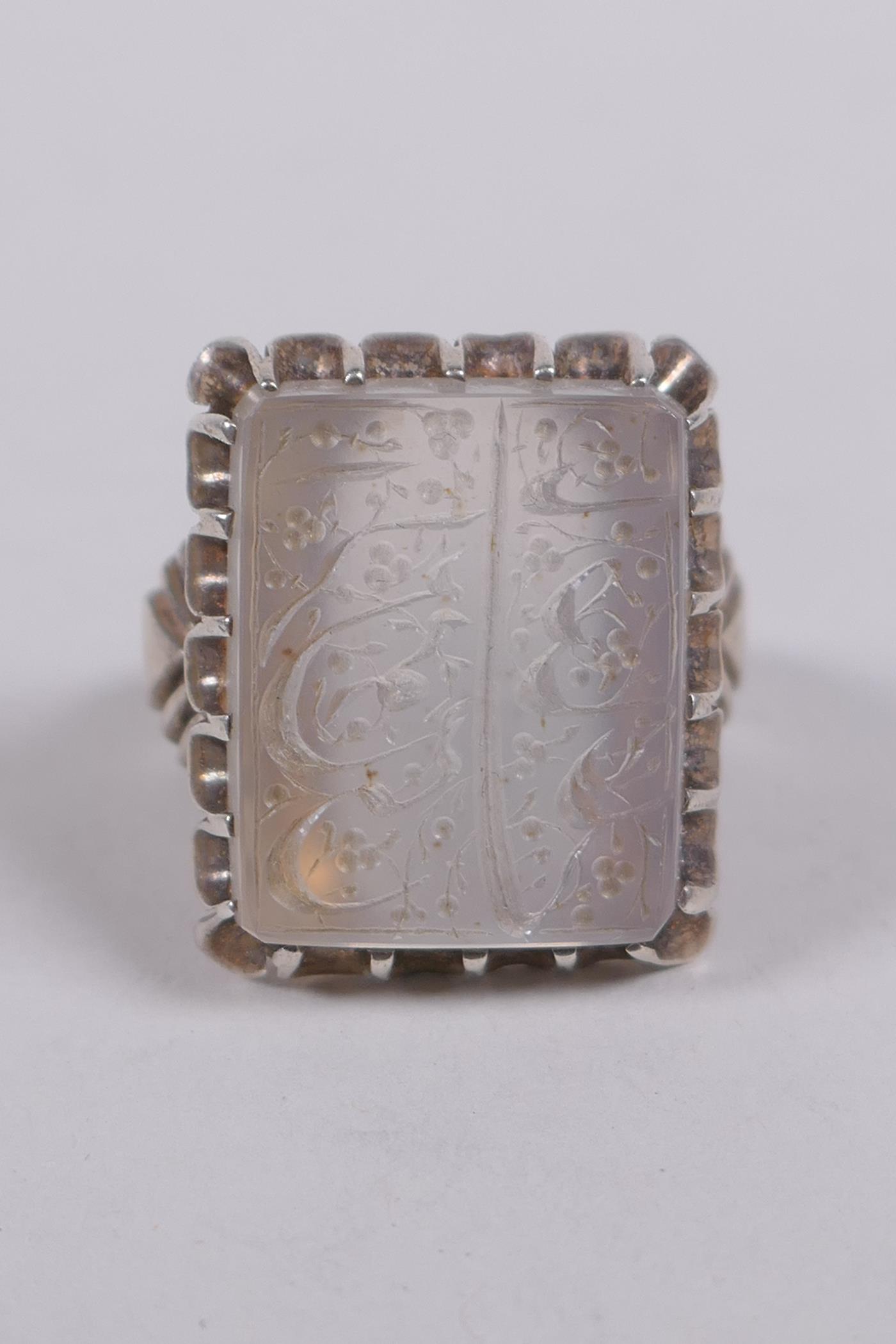 An Islamic white metal ring set with an intaglio seal carved with Islamic script, marks to interior, - Image 2 of 4
