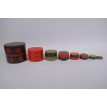 A set of oriental lacquered wood cylinder nesting boxes, largest 12cm diameter