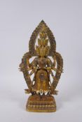 A Sino Tibetan gilt bronze figure of a many armed and headed deity, 28cm high