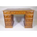 A Victorian mahogany nine drawer pedestal desk, with moulded feet details, wood knobs and inset