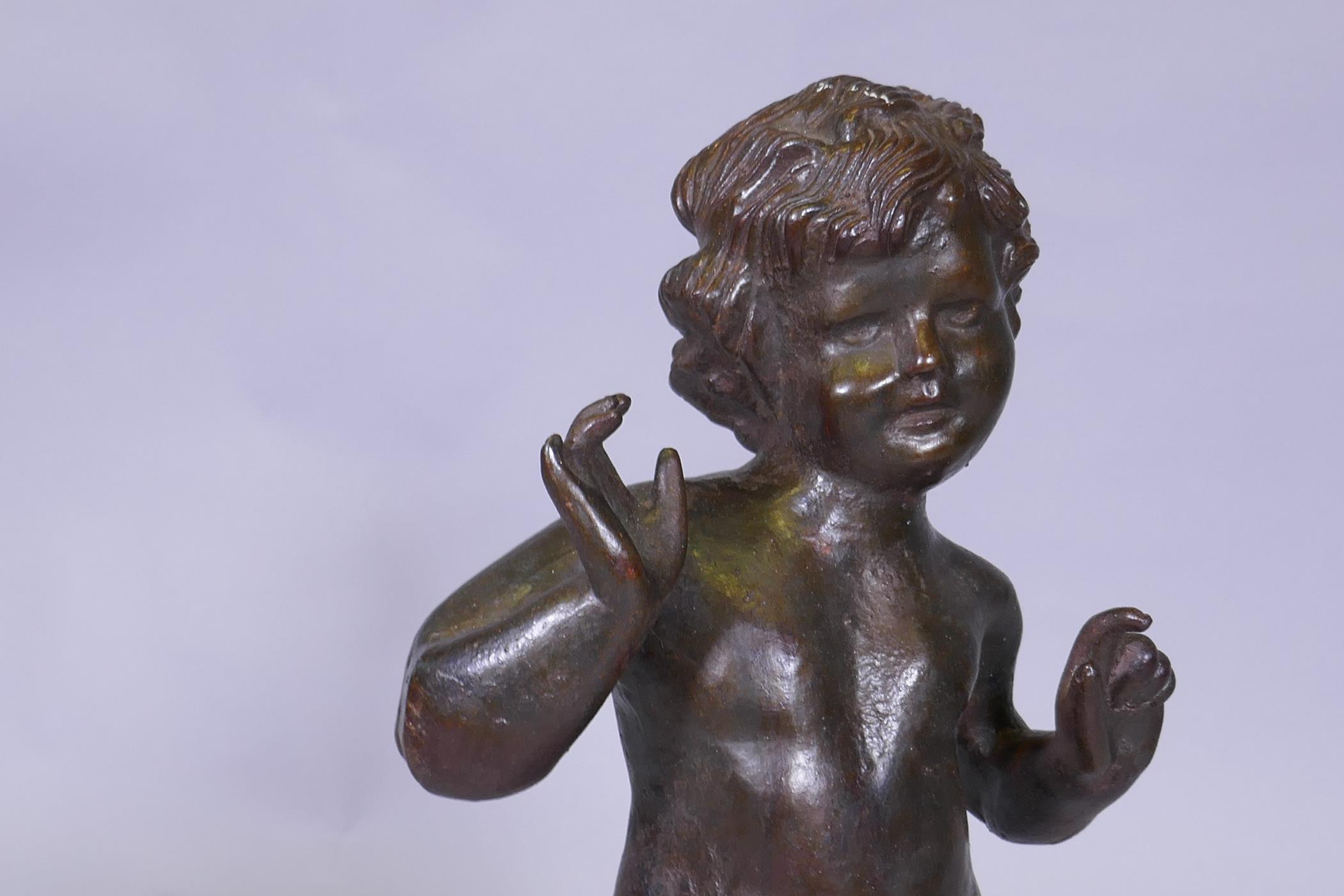 A cast iron figure of a putto, 53cm high - Image 2 of 3