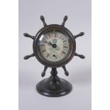 A bronze desk clock in the form of a ship's wheel, 15cm high