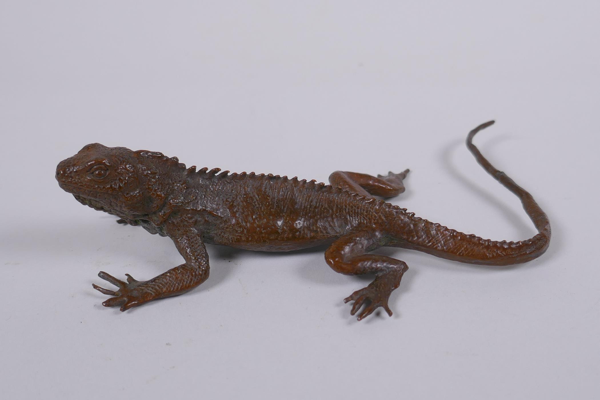 A Japanese style bronze okimono lizard, impressed mark to the base, 15cm long