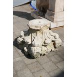 An antique carved and weathered stone capitol, 39cm high, 45cm wide