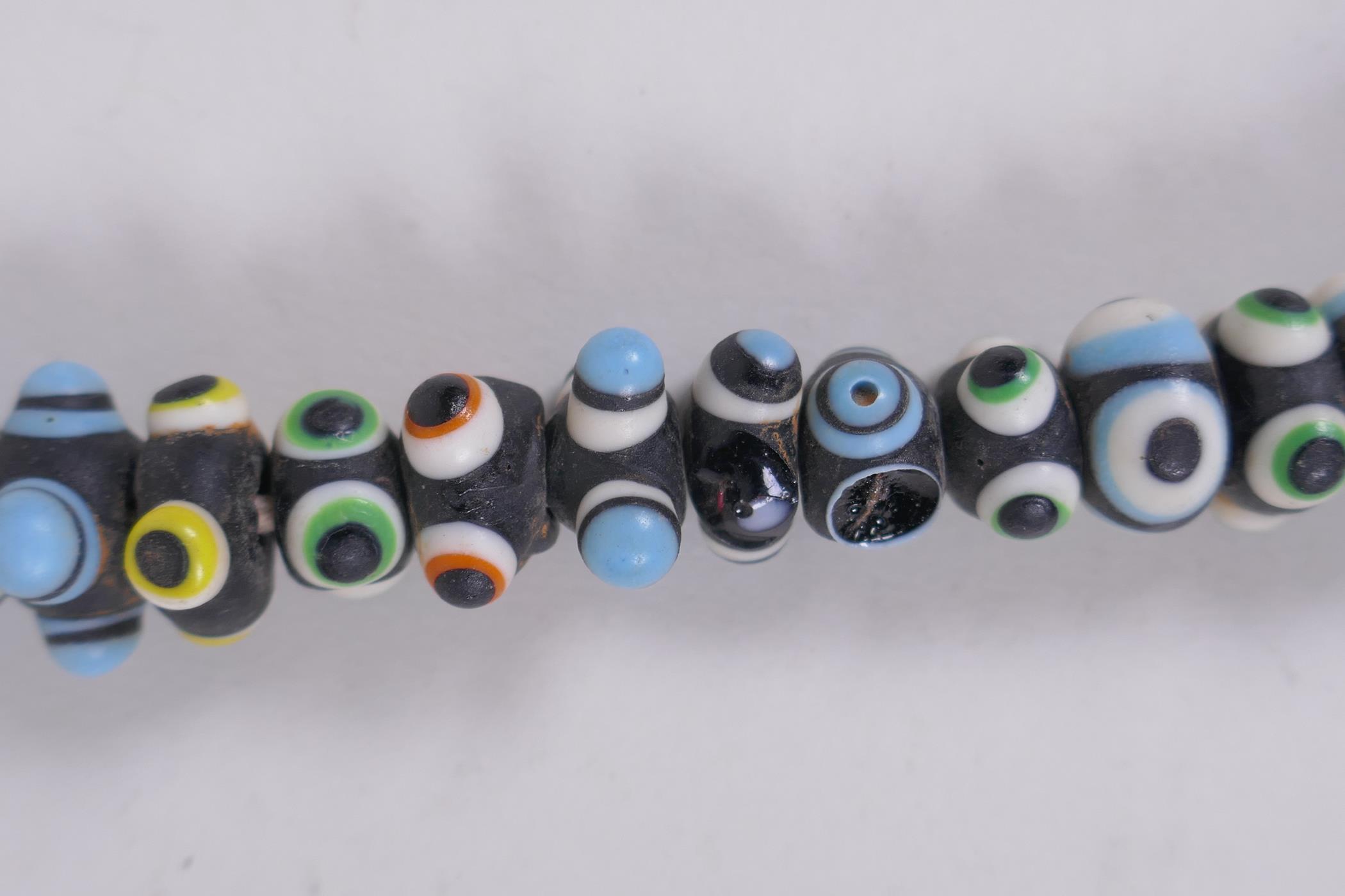 A Venetian glass eye bead necklace, 64cm long - Image 5 of 5