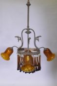 An early C19th continental pendant ceiling light with three branches and amber glass drops and