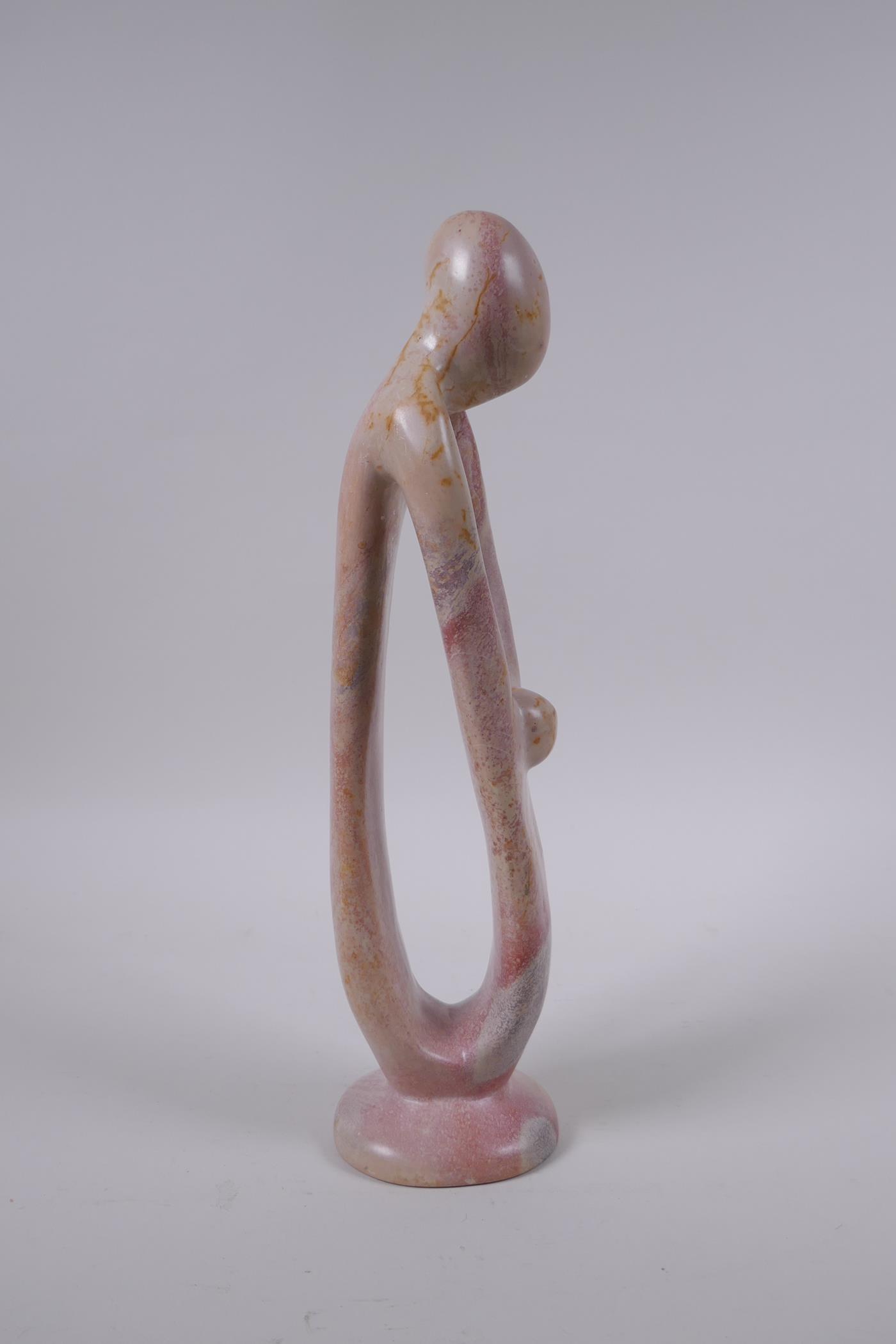 A Kenyan carved and polished Kisii stone figure group in the form of a mother and child, 23cm high - Image 3 of 5