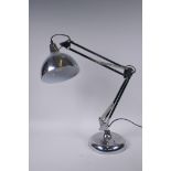 An adjustable chromed metal desk light