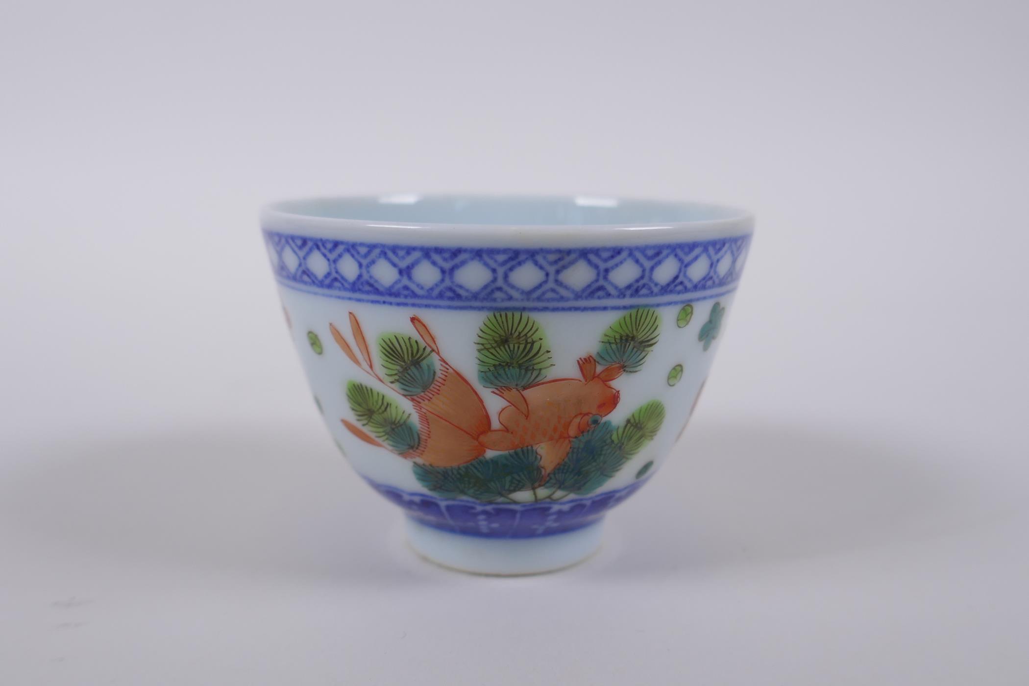 A blue and white porcelain tea bowl with iron red goldfish decoration, Chinese Dao Guang seal mark