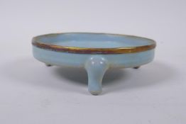 A Chinese Ru-ware style porcelain shallow censer raised on tripod supports with gilt metal rim, 14cm
