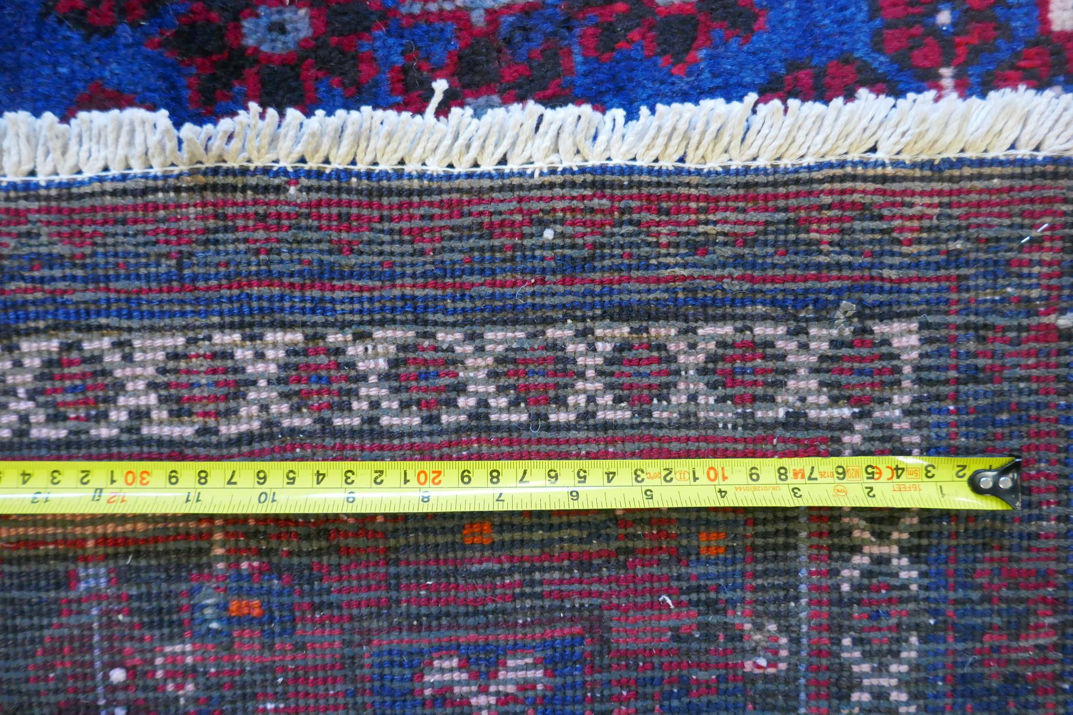A claret and blue ground Persian Joshaghan tribal carpet with traditional medallion design, - Image 7 of 7
