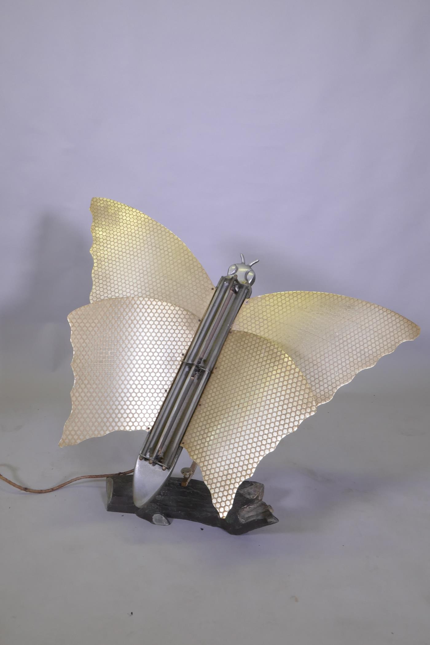 An Art Deco butterfly room heater, on an aluminium swivel arm, on a naturalistic log base, 77cm high