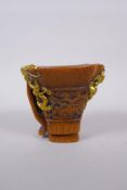 A Chinese faux horn libation cup with carved and gilt painted kylin decoration, mark to base, 11cm