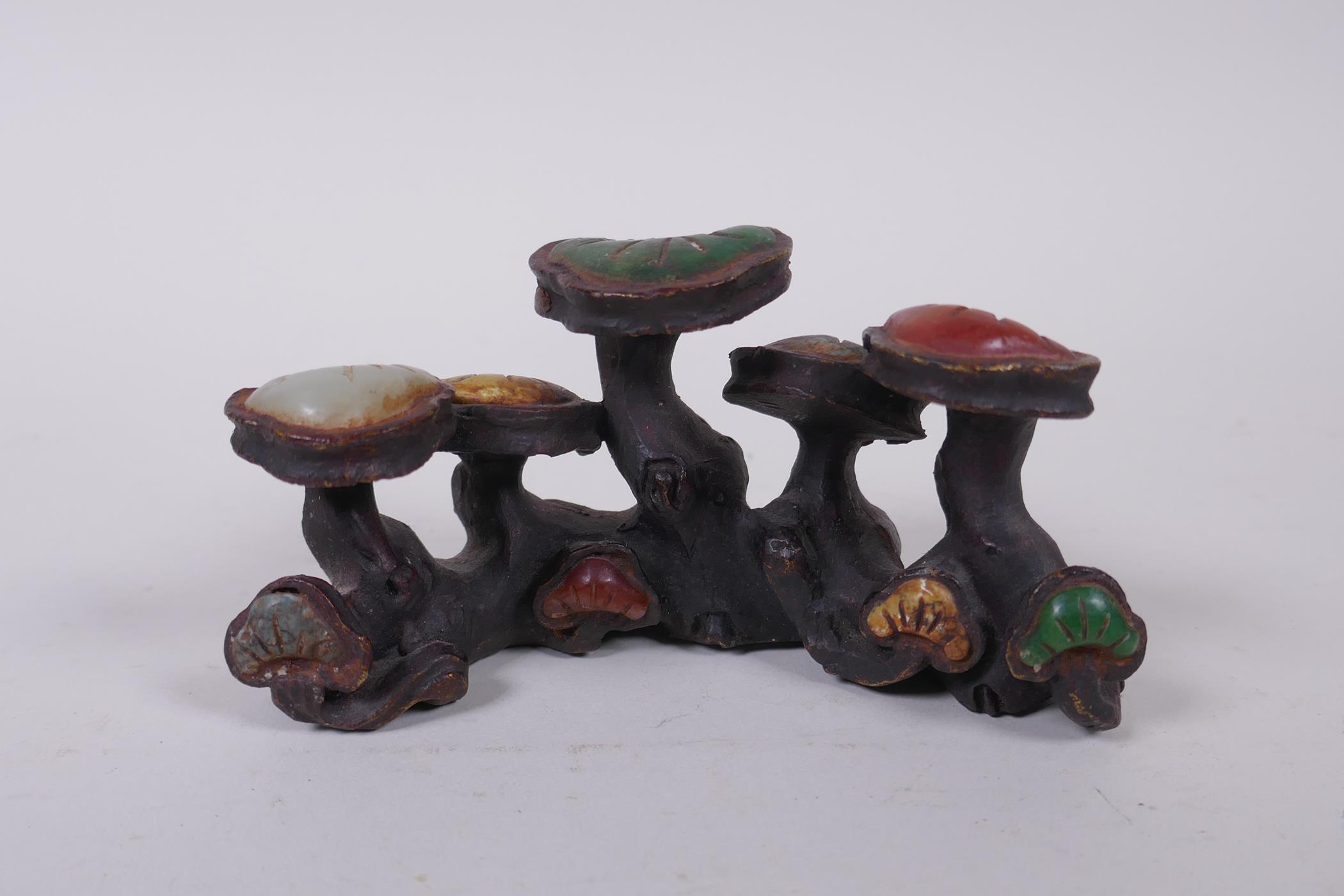 A Chinese bronze brush rest of Ruyi form, with inlaid hardstone and agate decoration, 13cm long