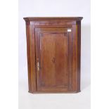 A Georgian oak hanging corner cupboard, 75 x 99cm