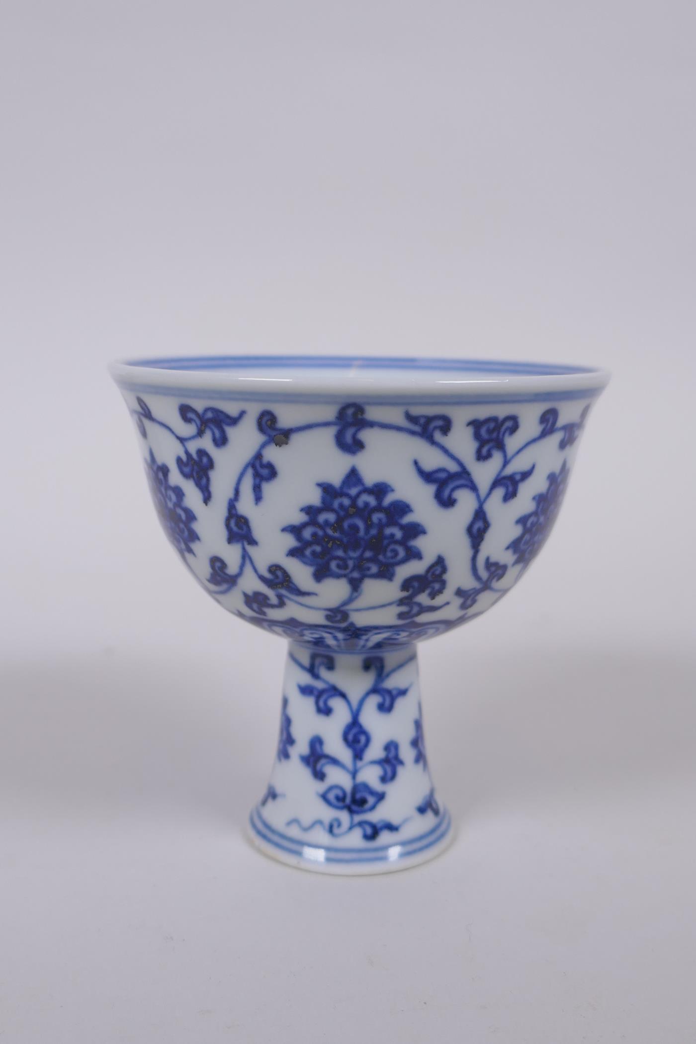 A blue and white porcelain stem cup with lotus flower decoration, Chinese Xuande 6 character mark to