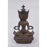 A Tibetan bronze multi headed Buddha with remnants of gilt patina, 31cm high