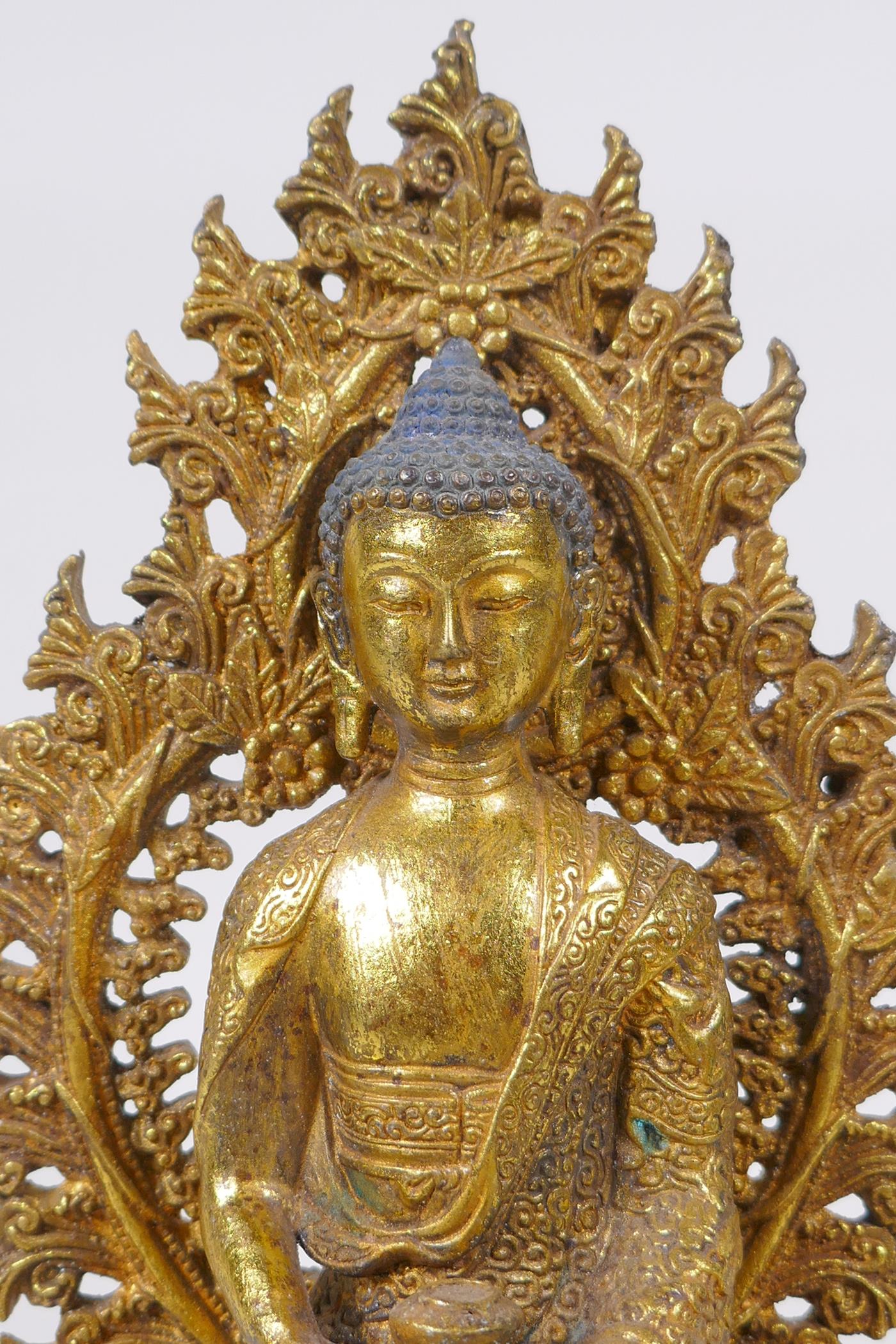 A Sino Tibetan gilt bronze figure of Buddha seated on a dias, Chinese 4 character mark verso - Image 2 of 7