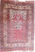 An antique Persian prayer rug, with lantern design, on a red field, 95 x 137cm