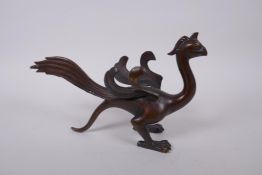 A Chinese filled bronze phoenix, 27cm long