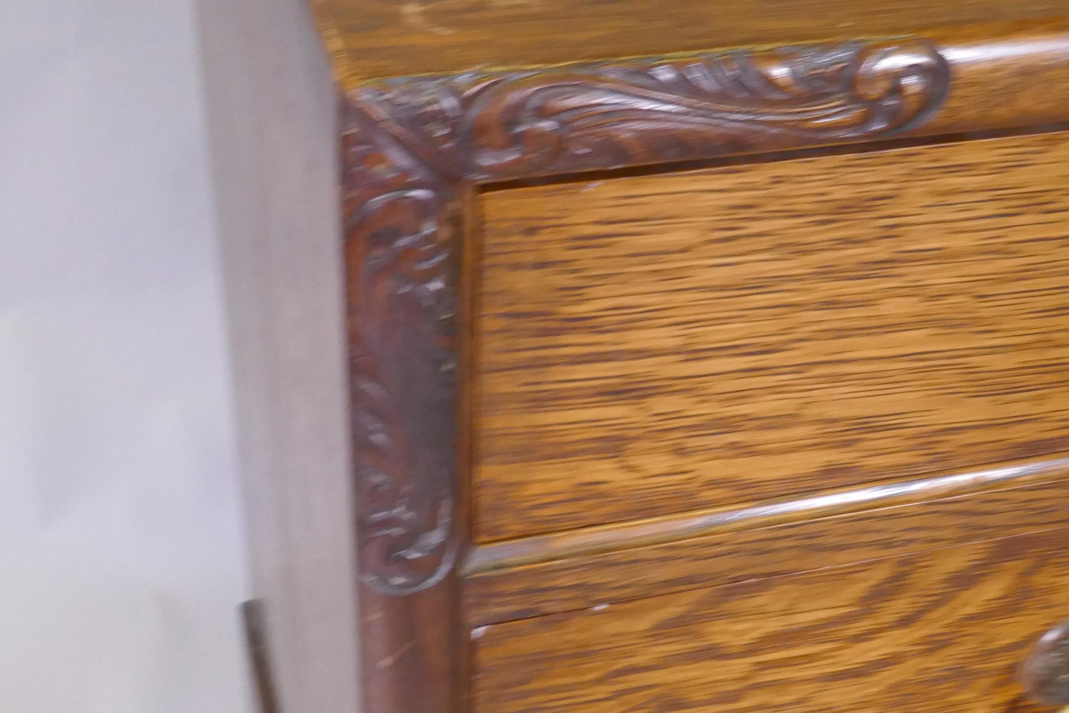 An Arts & Crafts oak chest of two over two drawers, with carved decoration and brass handles, raised - Image 4 of 5