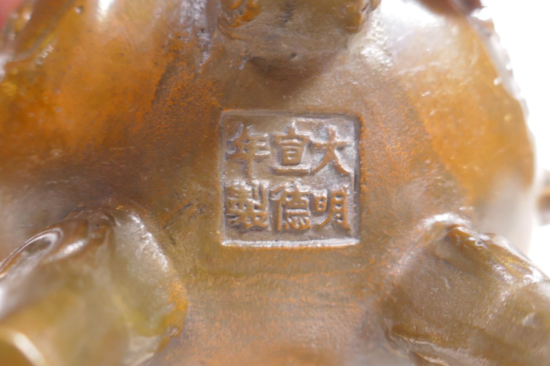 A Chinese bronze two handled censer and cover raised on tripod supports with raised dragon - Image 5 of 5