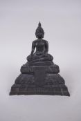 A Tibetan bronzed metal Buddha seated in meditation, 18cm high