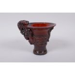 A Chinese horn libation cup with climbing kylin decoration, character mark to base, 12cm high