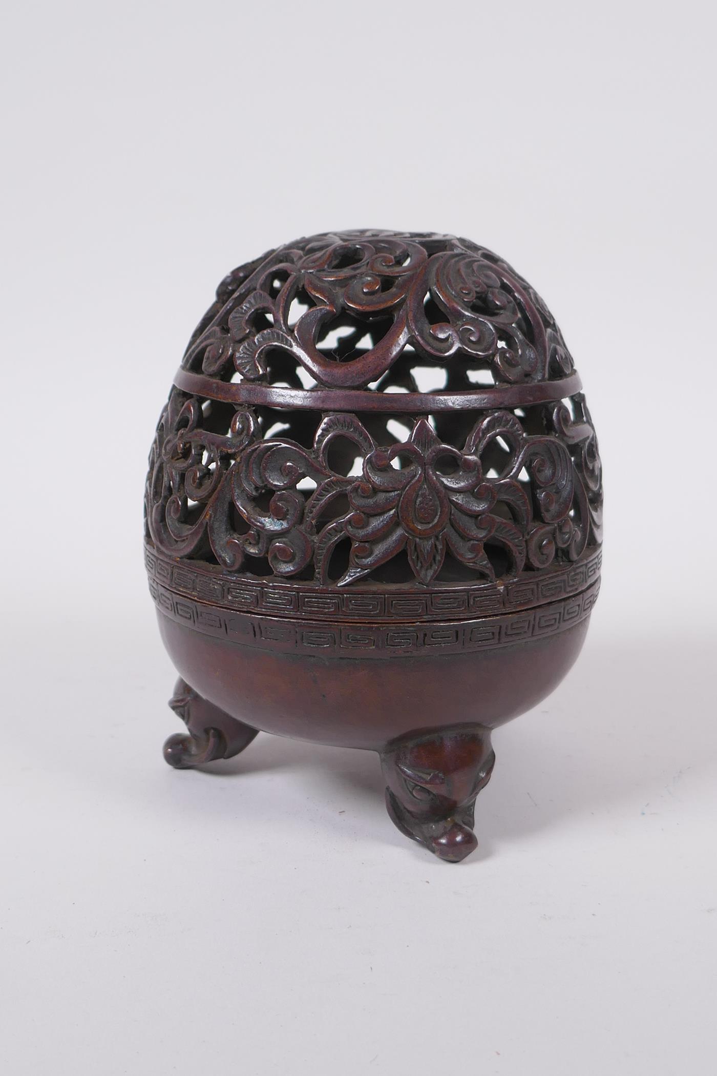 A Chinese bronze censer and pierced cover with tripod supports and scrolling floral decoration, 4 - Image 3 of 5