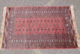 A Turkish terracotta ground wool rug with all over geometric design, 98 x 154cm