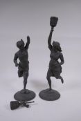 A pair of antique bronzed spelter candlesticks in the form of Moors bearing torcheres, 40cm high, AF