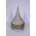 An antique Indo Persian brass brasserie and conical cover, raised on tripod supports, with chased