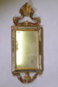 A Venetian painted and giltwood cushion shaped wall mirror, early C20th, 35 x 90cm