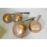 Four antique tinned copper Middle Eastern cooking vessels, one handle engraved with Arabic script,