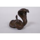 A Japanese style bronze okimono cobra, mark to base, 4cm high