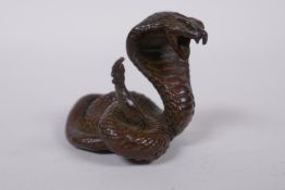 A Japanese style bronze okimono cobra, mark to base, 4cm high