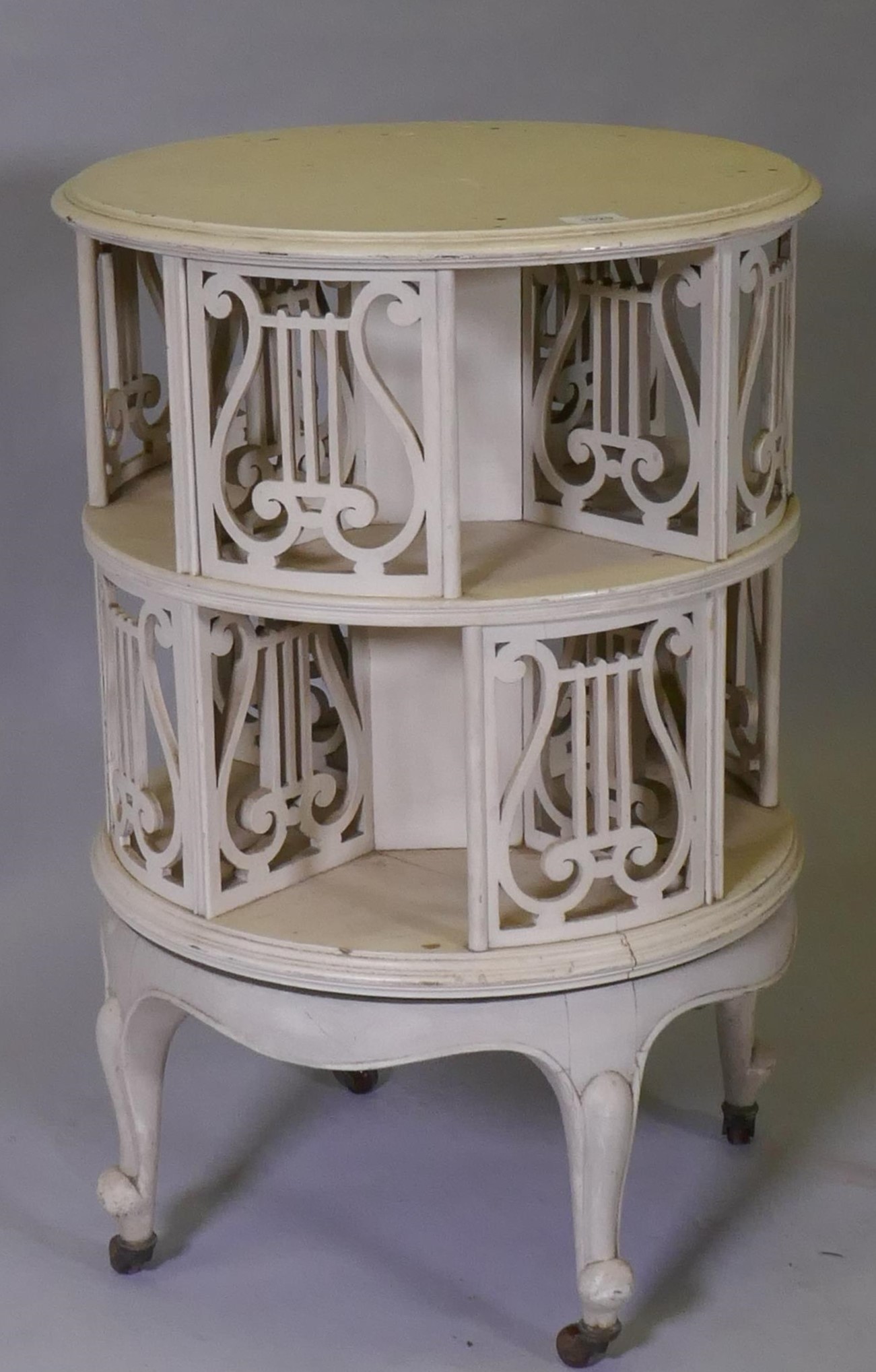 A Victorian revolving bookcase with pierced lyre shaped decoration, raised on cabriole supports with - Image 2 of 3