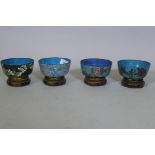 Four Chinese cloisonne enamel bowls on wood stands, late C19th/early C20th