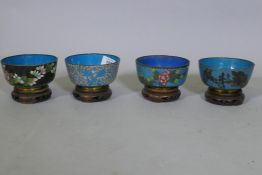 Four Chinese cloisonne enamel bowls on wood stands, late C19th/early C20th