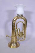 A brass tuba converted to a table lamp, 76cm high