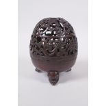 A Chinese bronze censer and pierced cover with tripod supports and scrolling floral decoration, 4