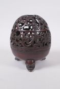 A Chinese bronze censer and pierced cover with tripod supports and scrolling floral decoration, 4