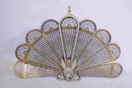 A brass fan shaped fire guard, 97 x 60cm high