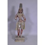 An Indian carved and painted wood Buddhistic figure, 92cm high