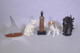 A painted wood carved cat, a ceramic figure of a dog, a carved and painted wood Buddha, a