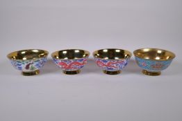 Four Chinese polychrome porcelain footed rice bowls with gilt lustre glazed interiors and feet,