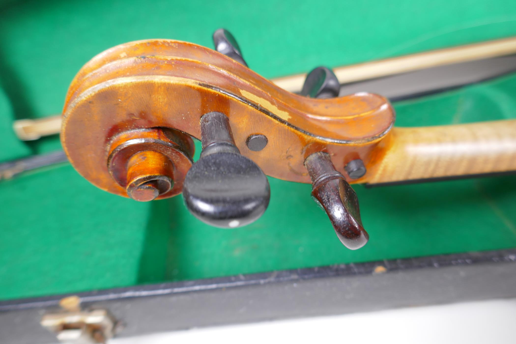 A vintage violin with two piece back and ebony pegs, with a bow and hard carry case, 60cm long - Image 4 of 7